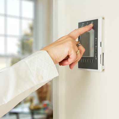 Person Adjusting Their Thermostat