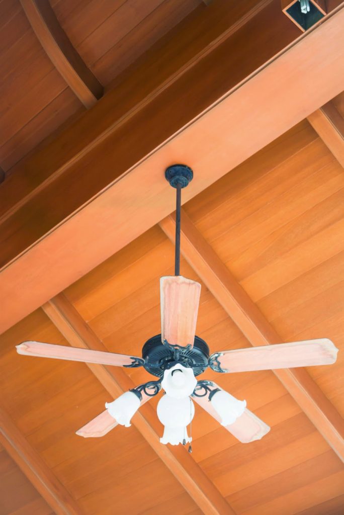 ceiling fan attached to a wood ceiling