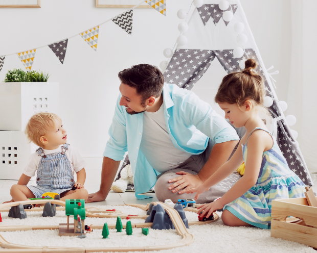 family of three playing together in a child's room