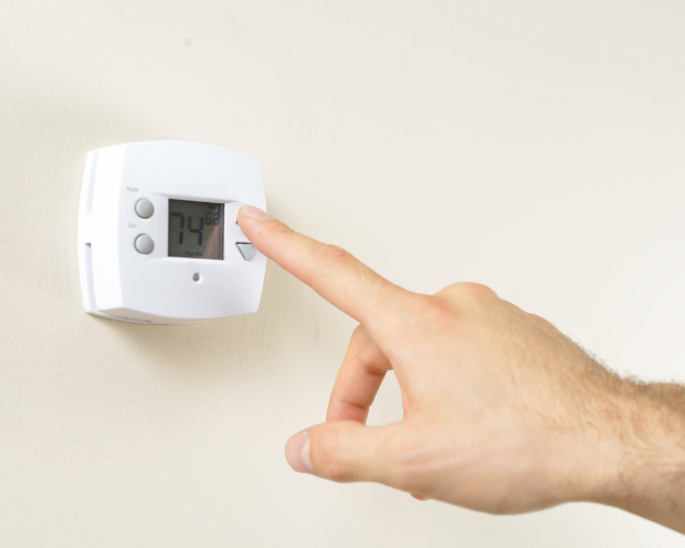 hand adjusting digital thermostat